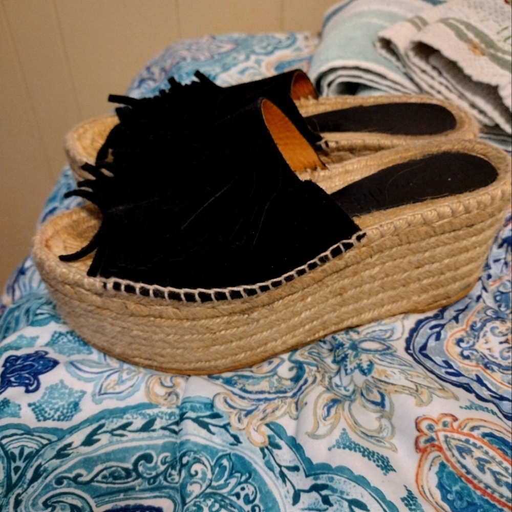 Fringe stacked sandals.
